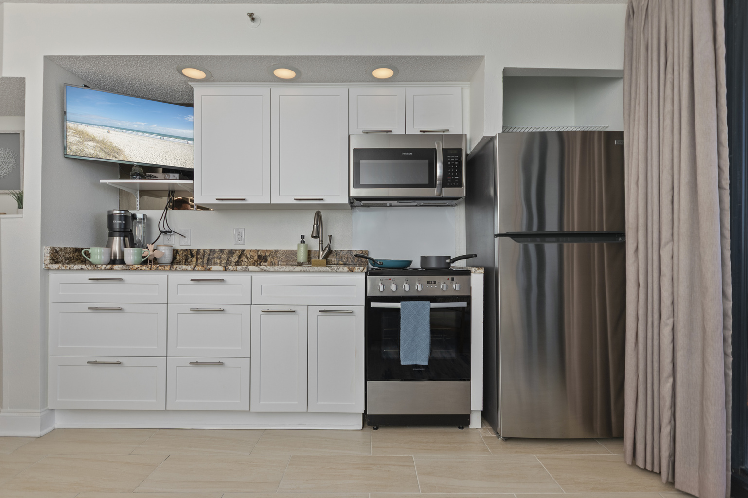 Kitchenette with everything you need to cook at home. Fully stocked with pots, pans, dishes, utensils, spices, water filter, coffee pot and pods, and cleaning supplies. 