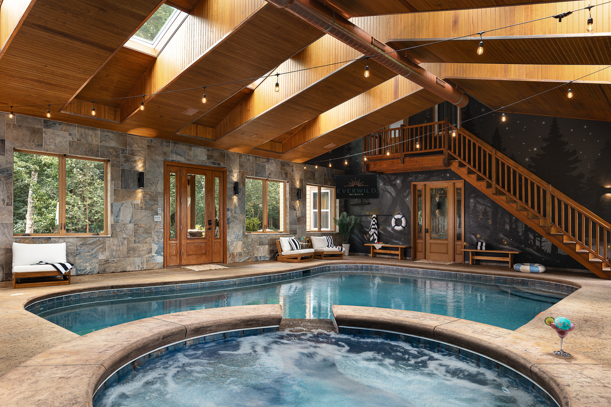 {Indoor Pool & Hot Tub} Swim year-round in your private indoor pool, then step straight into the bubbling hot tub beneath soaring timber beams and string lights.