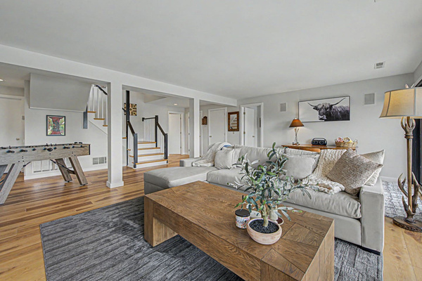 The hang-out floor. Deep sectional, easy light, the room you sink into after a day at the pool.
