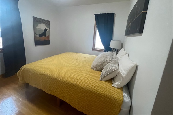 Third bedroom with closet and luggage rack.