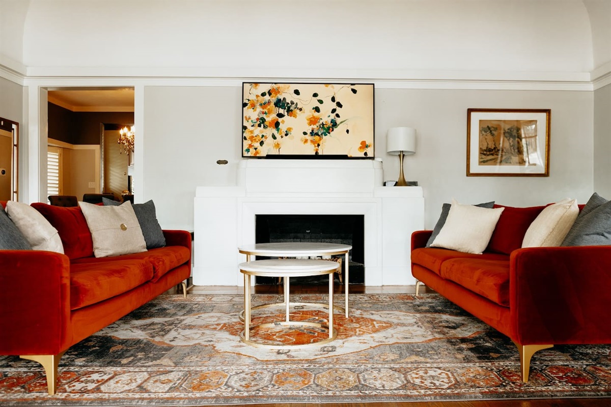 Relax in the "living hall". Plenty of seating for conversation or taking in a movie. The "art work" above the fireplace is a 65" TV. 