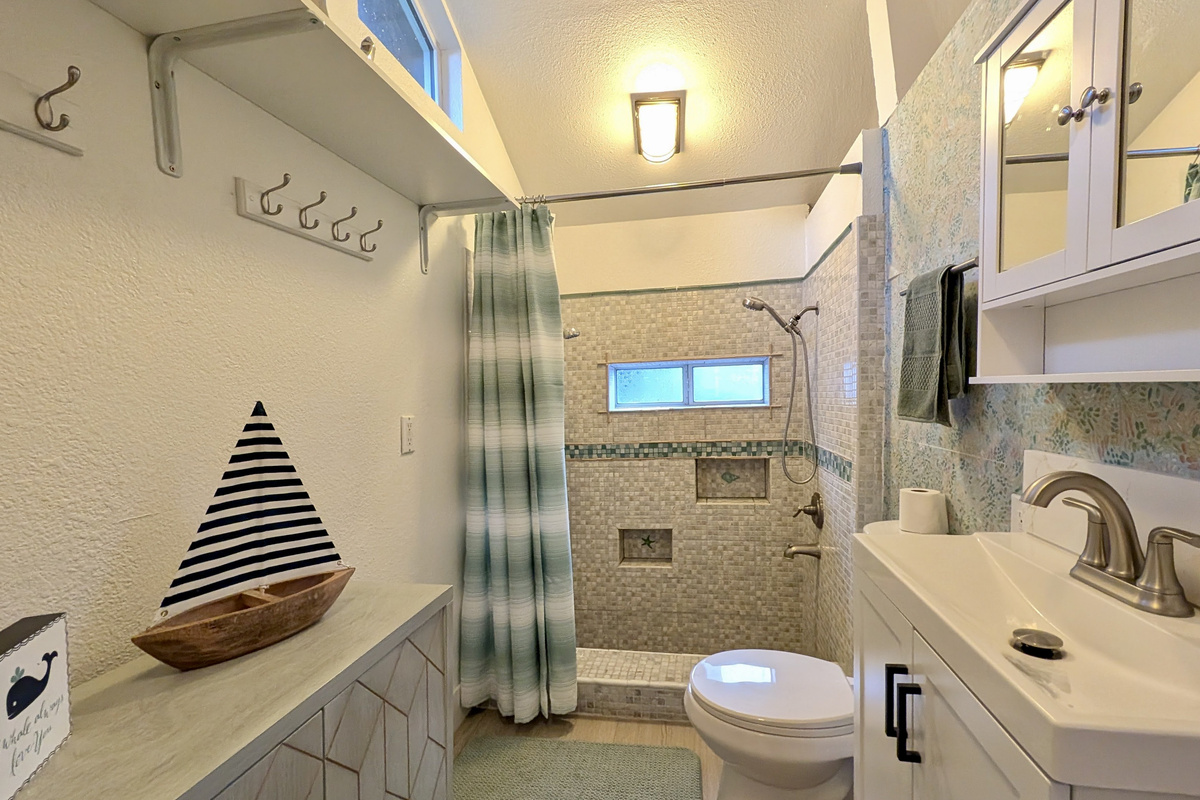 Thoughtfully designed with a large walk-in shower, modern vanity, and plenty of storage, this bathroom combines style and convenience for a comfortable stay.