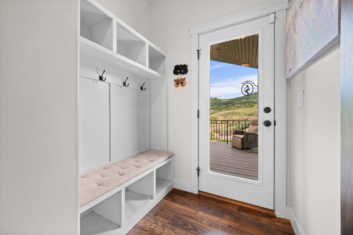 Functional mudroom with bench seating, storage, and direct access to the deck and outdoor living spaces.