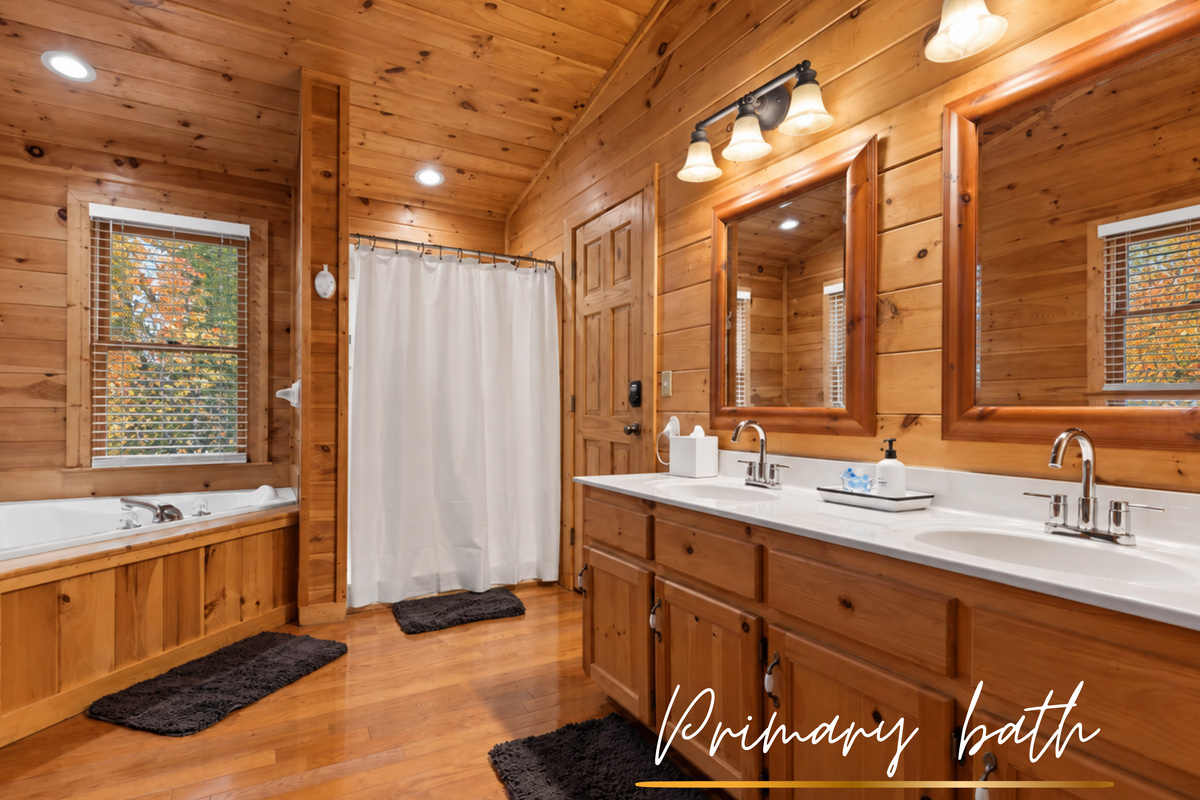 Spa-inspired luxury... a bathtub with forest views, double vanity, and a walk-in shower.
