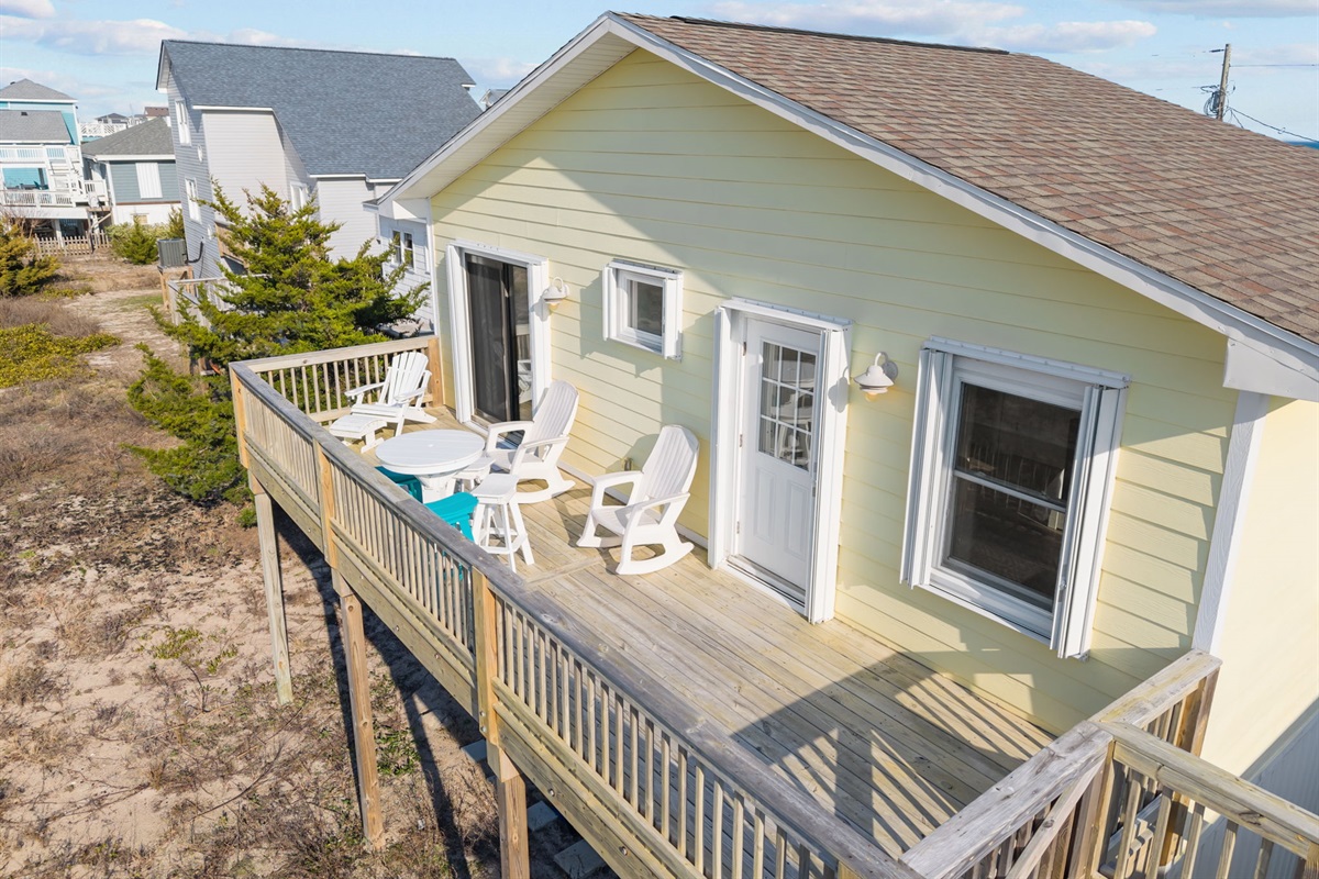 Sunlit deck with outdoor seating, ideal for morning coffee or evening sunsets