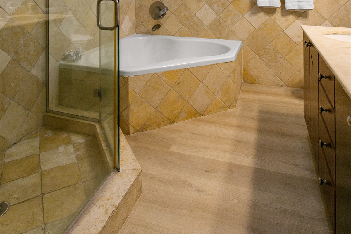 Primary Suite en-suite with separate tub and walk-in shower, double-sink vanity