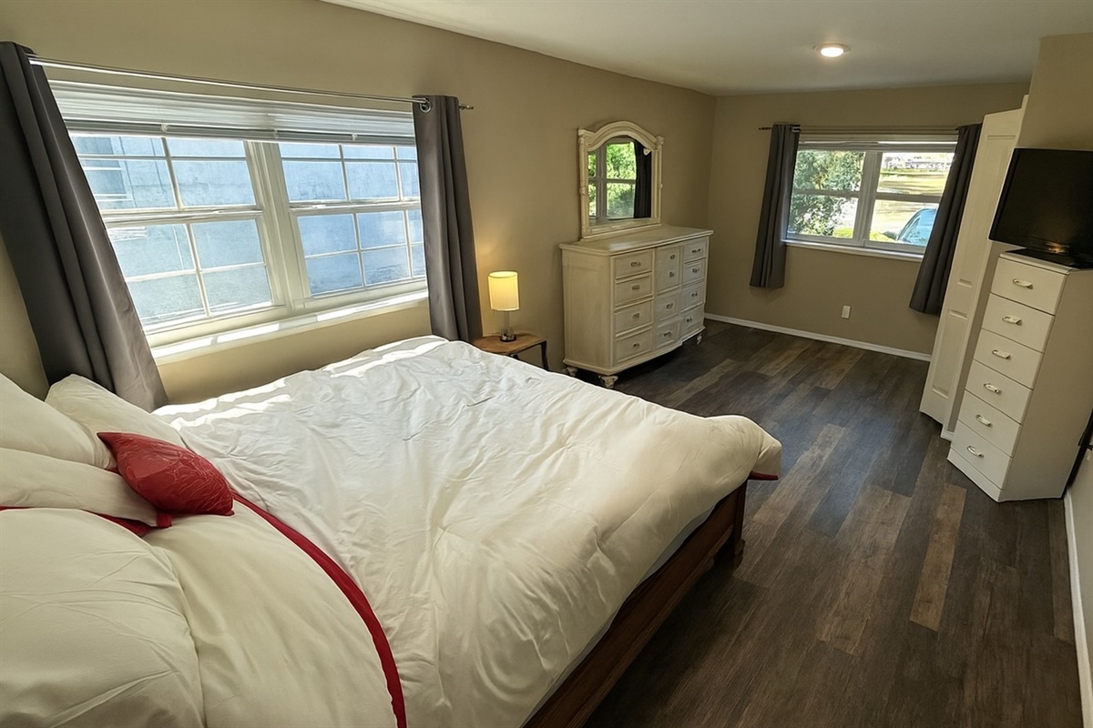 Bright bedroom with a plush queen bed, cheerful decor and ample natural light—the perfect retreat after enjoying Madeira Beach and Johns Pass during your midterm stay in Seminole, FL.