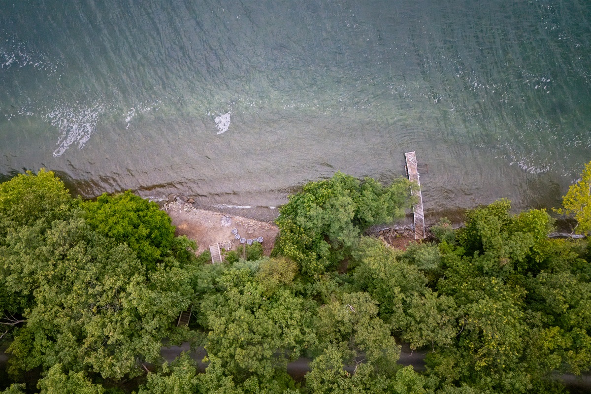 Stunning aerial perspective showcasing lakefront homes with private docks, sandy shoreline, and breathtaking Finger Lakes scenery.