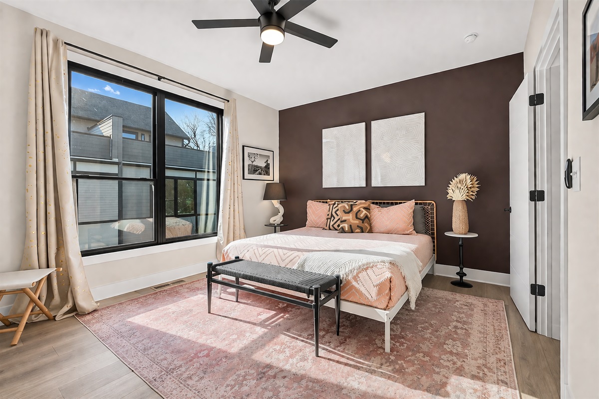 This 3rd floor primary suite has a luxurious king-sized bed and mounted TV (opposite wall) for your viewing pleasure. The overhead fan maximizes air flow for optimal sleep after a day of fun in Charlotte. 