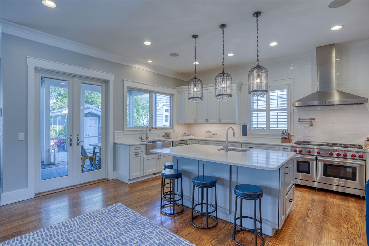 Fully equipped gourmet kitchen with Wolf appliances and generous island for gathering