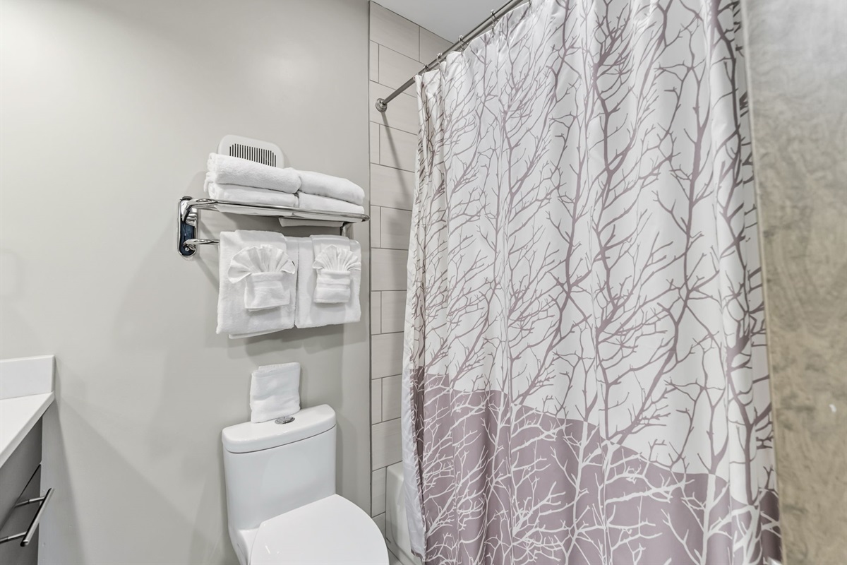 Full bathroom with two sinks, tub/shower