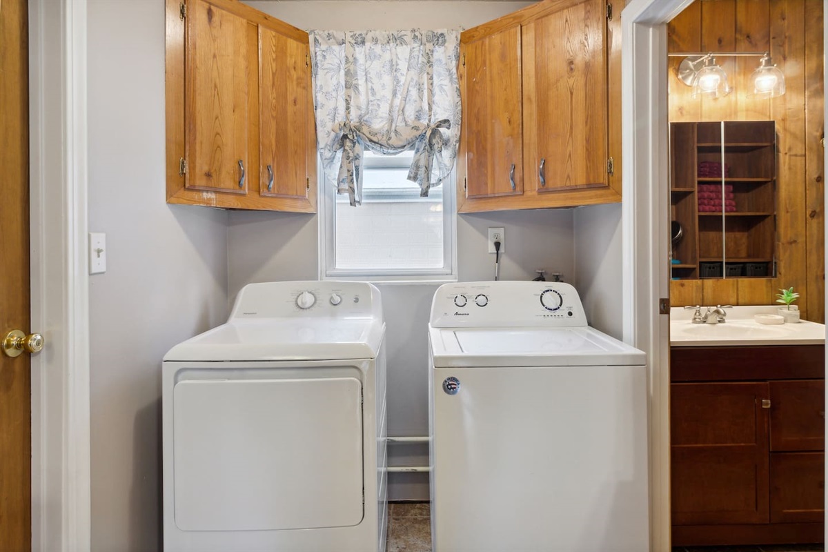 Side-by-side washer and electric dryer. Storage above for soap and other amenities. Closet to the left is unavailable for use, it is used for our supply closet.