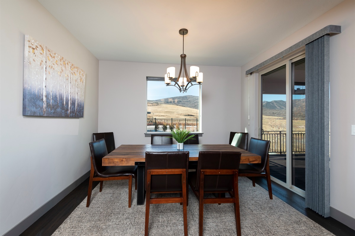 Dining area with scenic views and access to outdoor deck.