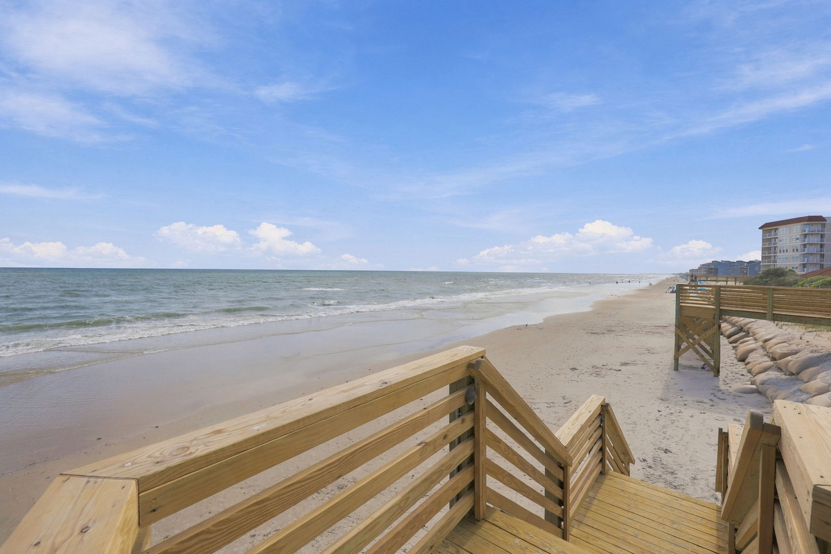 Take the private wooden boardwalk right over the dunes and straight onto the sand.