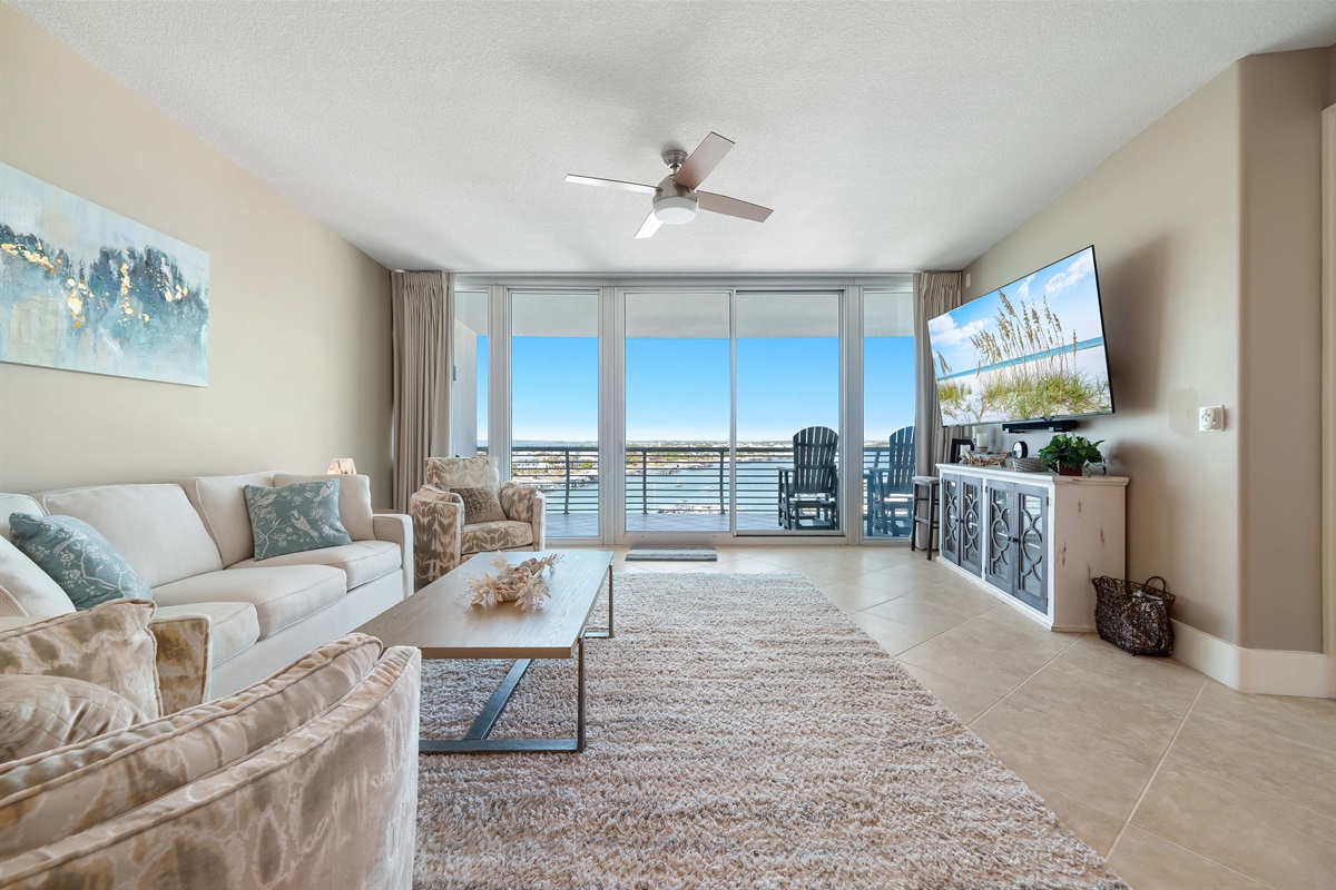 Unwind and soak in the beauty of Ole River and Ono Island from this stunning living room. The expansive windows offer unparalleled views, creating a seamless connection with the surrounding landscape.