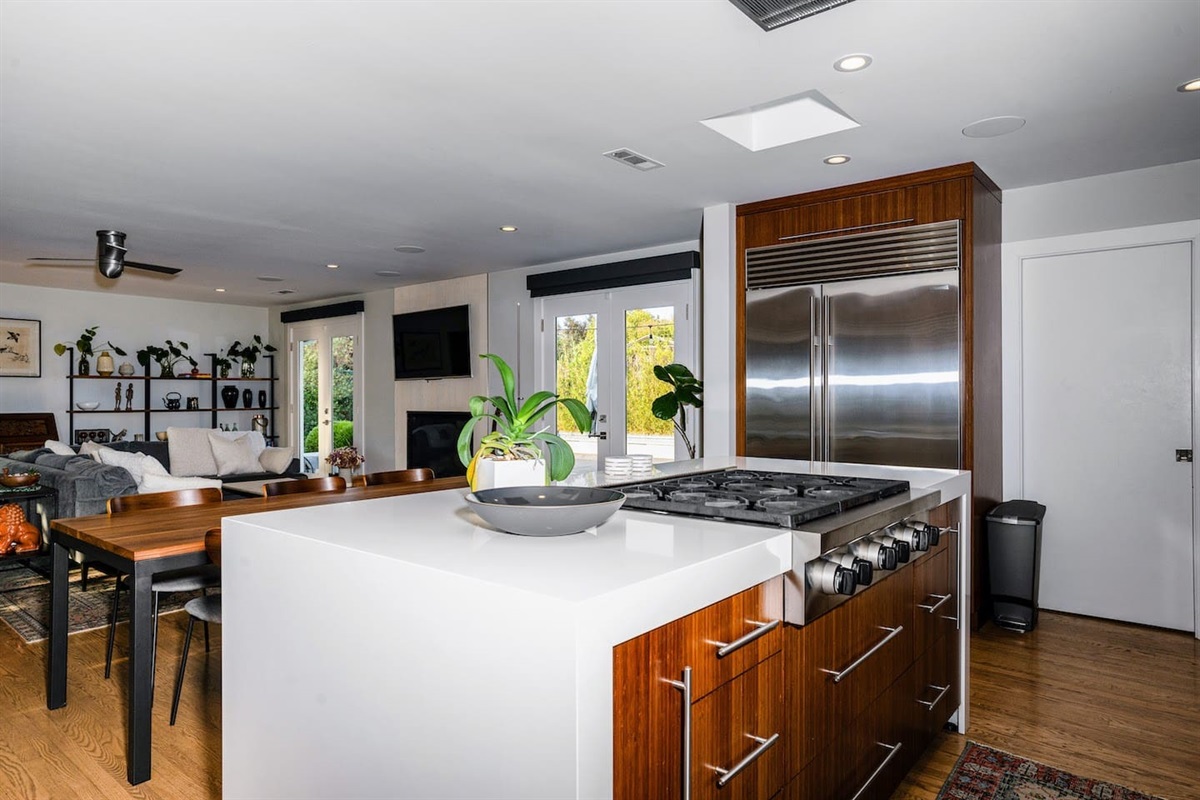 Fully stocked chef's kitchen with 8 person dining table and two person island seating.