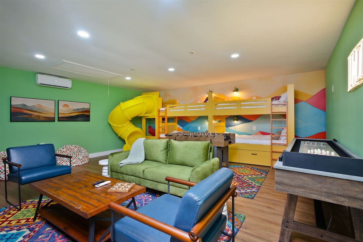  Epic kids’ zone with custom bunks, a yellow slide, and endless games.