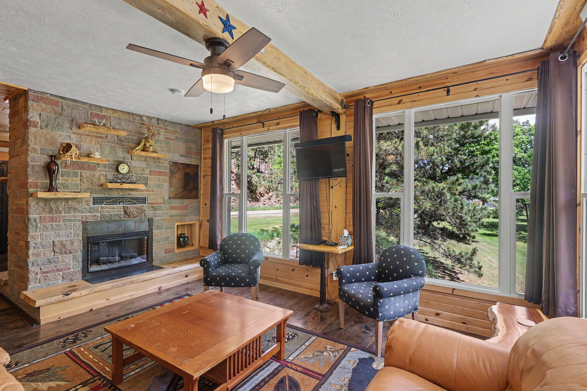 Family Room Fireplace and Picture Window views of Landscap and Stream