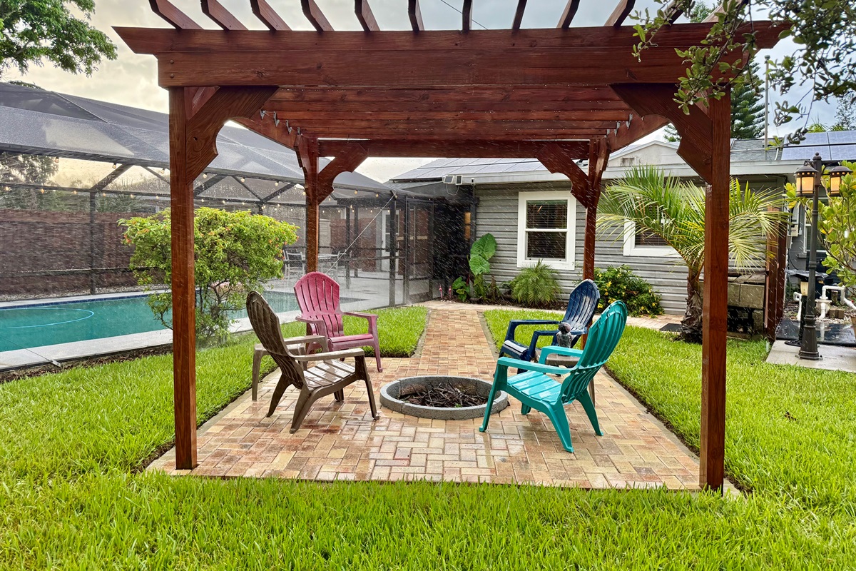 Tucked next to the pool and surrounded by palms, this peaceful pergola zone is ideal for day lounging or night gatherings.