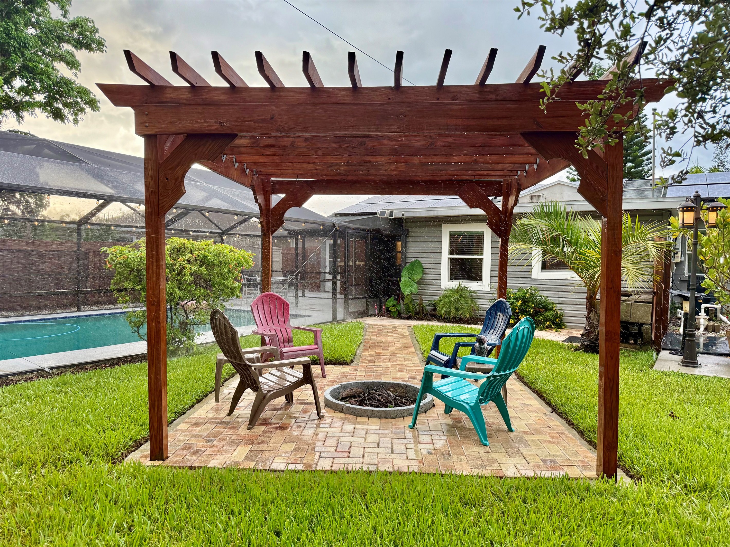 Tucked next to the pool and surrounded by palms, this peaceful pergola zone is ideal for day lounging or night gatherings.