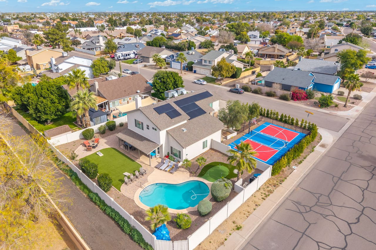 An entertainer's dream from above — pool, court, and space to spare.