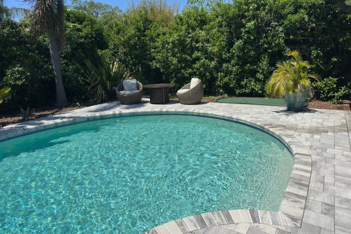 Clear blue pool surrounded by greenery for calm escapes.