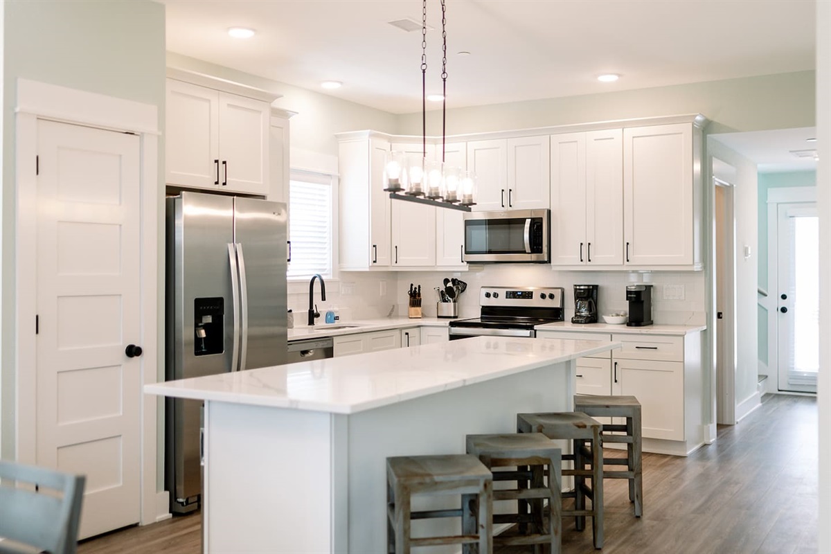 Bright coastal kitchen featuring stainless steel appliances and generous prep space.