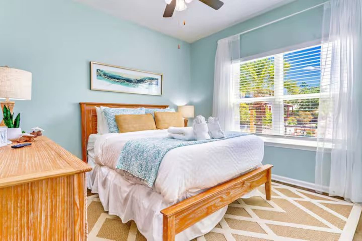 Bedroom 3: Unwind in this inviting queen bedroom featuring soft linens, natural light, and peaceful beach-inspired decor