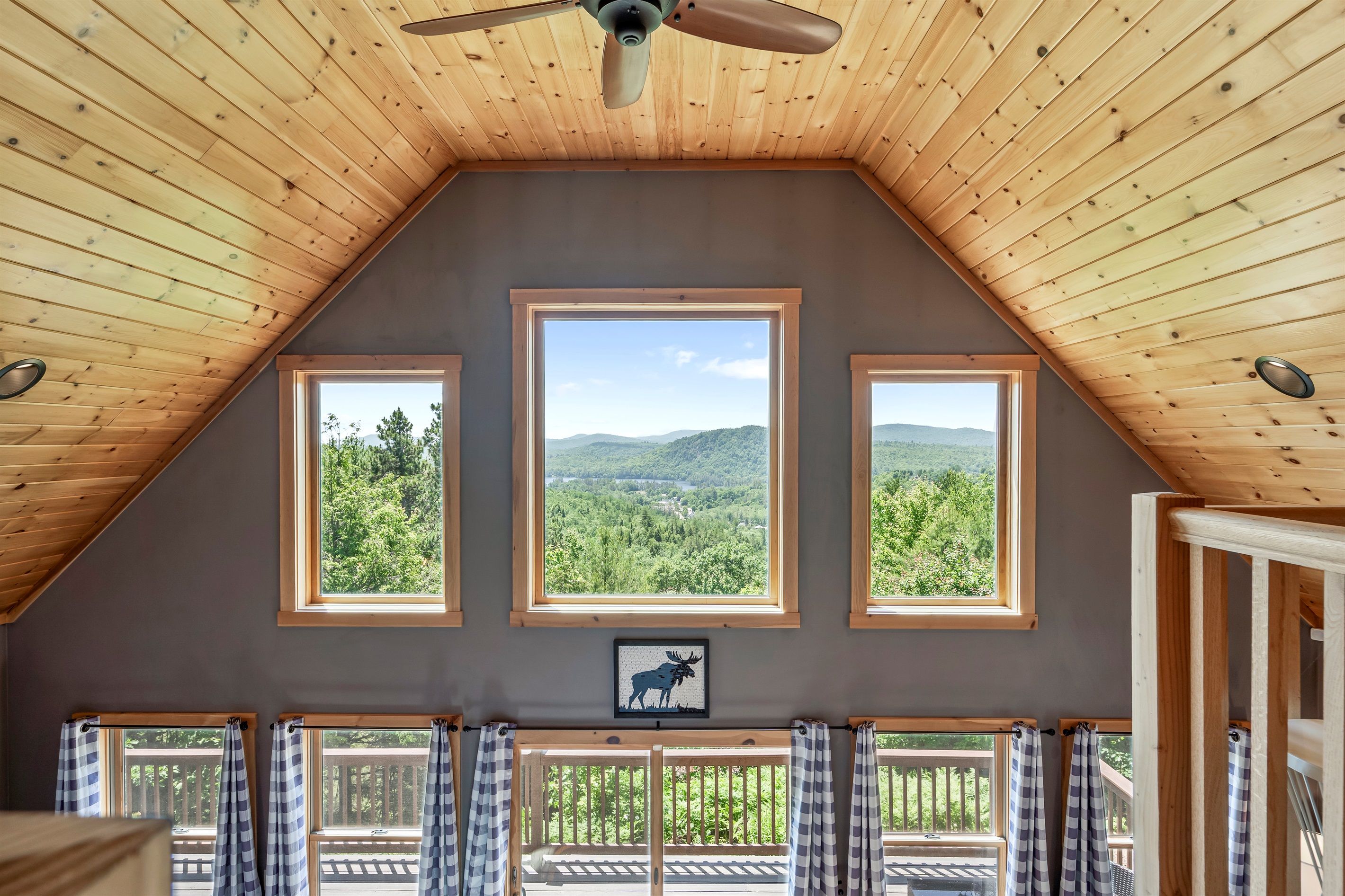 The second floor features a cozy reading loft, the master bedroom with king-size bed and barn door, a work space, and an ensuite bathroom.