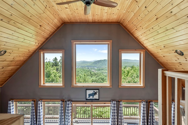 The second floor features a cozy reading loft, the master bedroom with king-size bed and barn door, a work space, and an ensuite bathroom.
