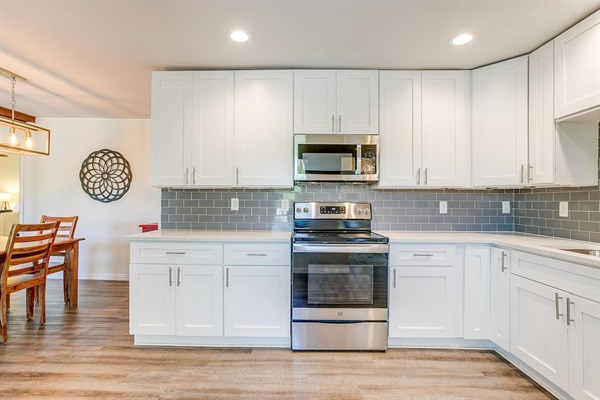 Bright, modern kitchen with stainless appliances and spacious countertops — fully equipped for cooking and entertaining.