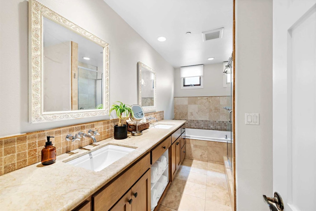The spa-like remodeled bathroom has twin sinks, a soaking tub, a music system, and a shower with excellent water pressure. 