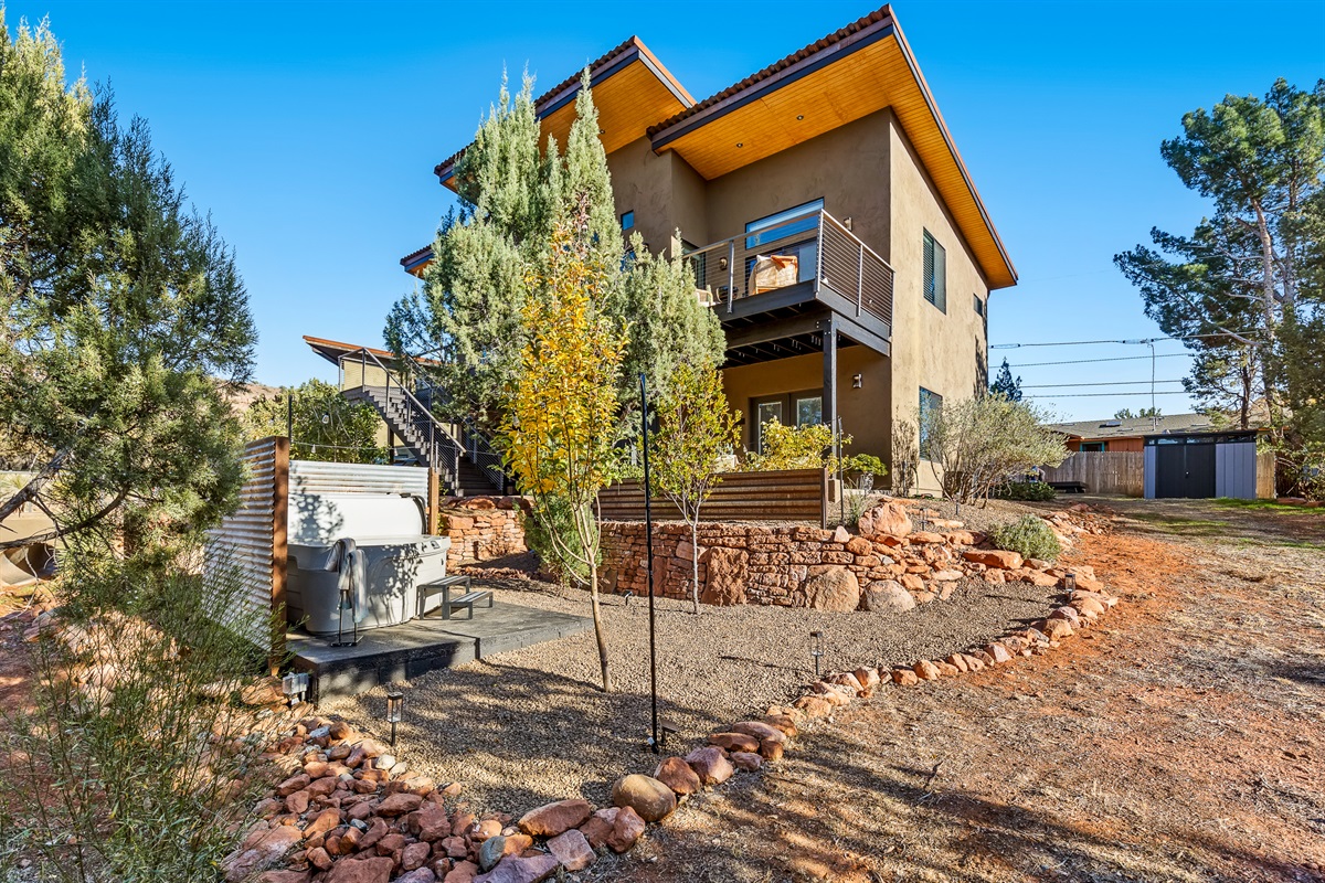 Guesthouse located beneath the main home, featuring a private outdoor hot tub area and peaceful desert landscaping in a Sedona setting.