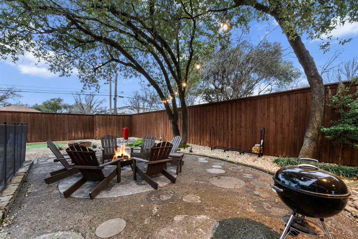 Make memories around the fire pit under string lights and towering trees.