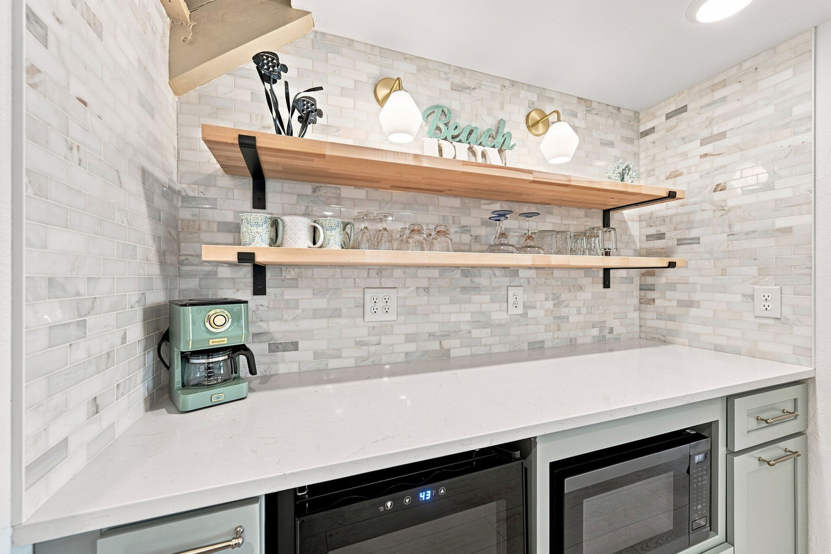 Coffee in the morning, wine in the evening—this space has you covered with a full-size coffee pot, microwave, and wine fridge.