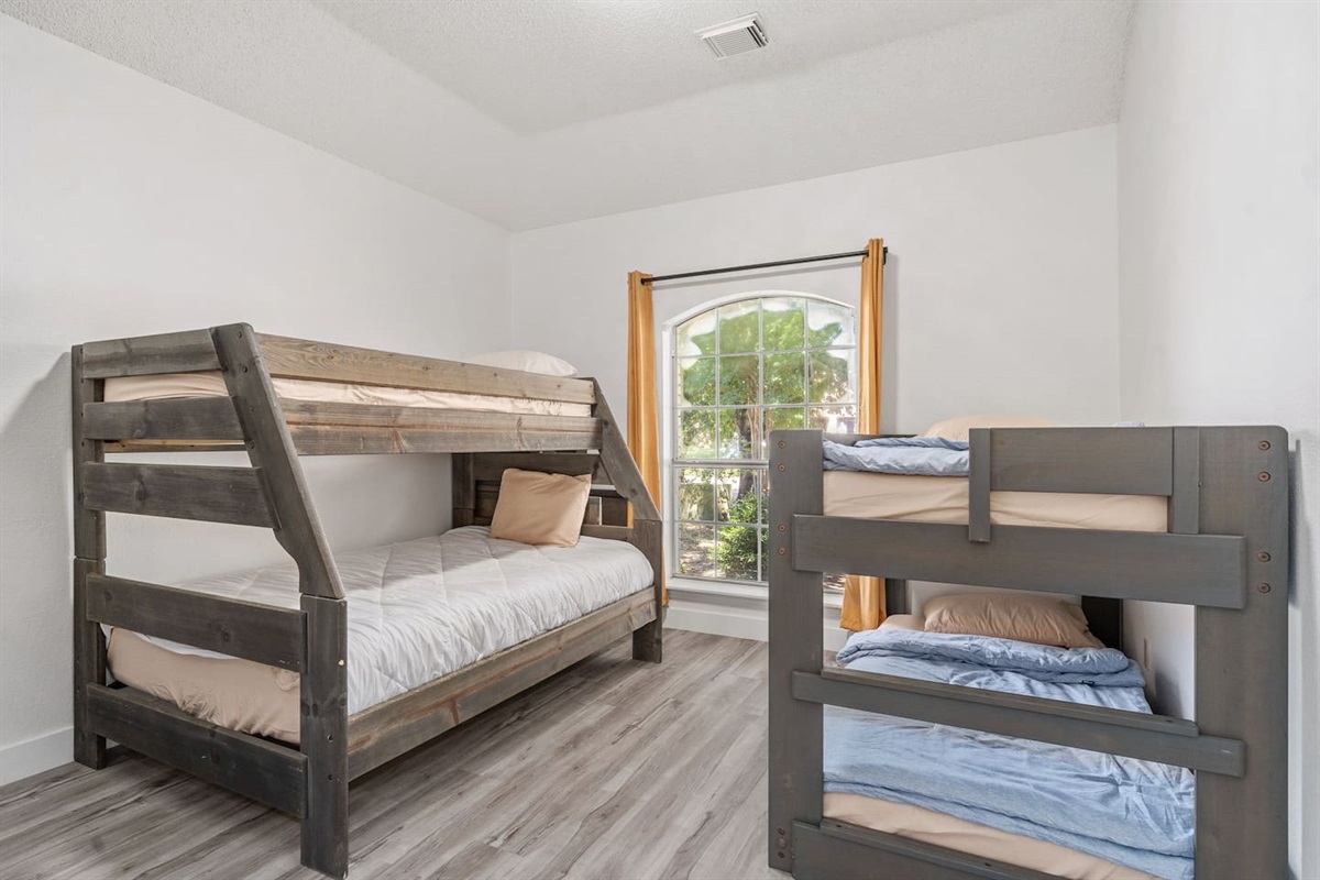 Bright and airy bedroom with two full sized bunk beds.