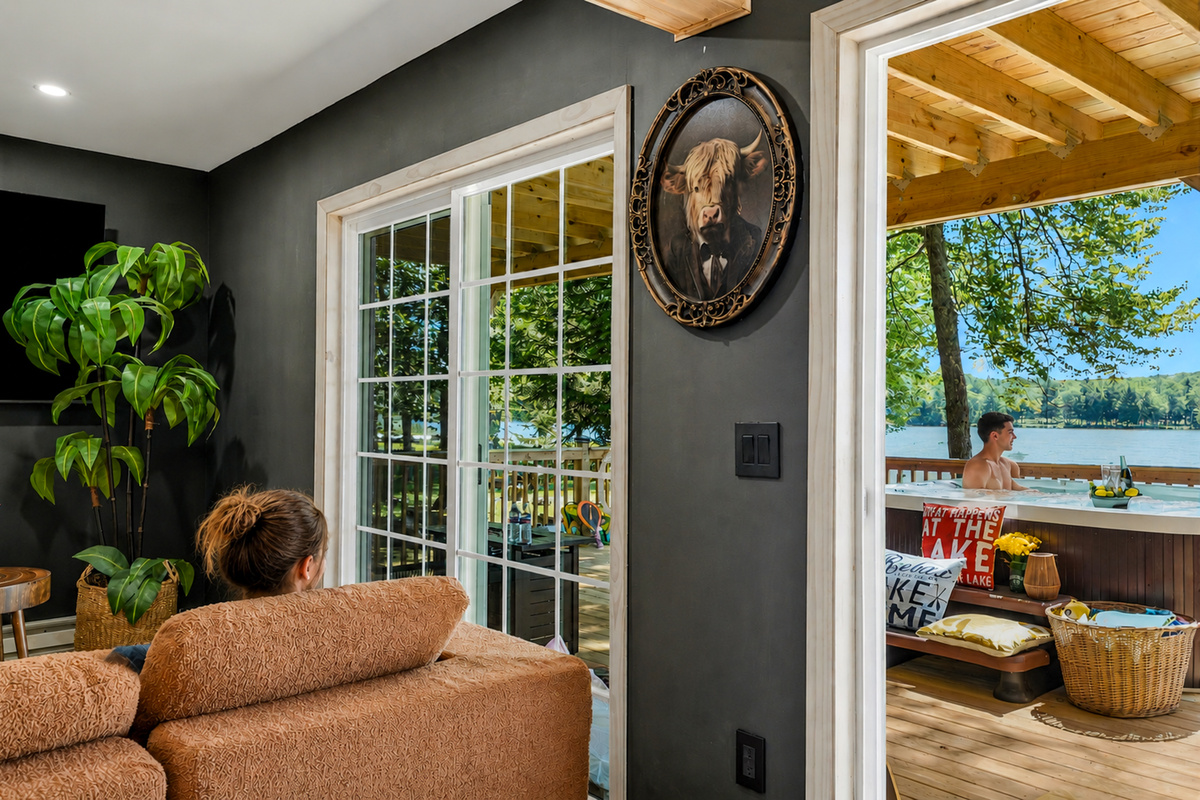 Lower-level living room with lake light pouring through the French doors
