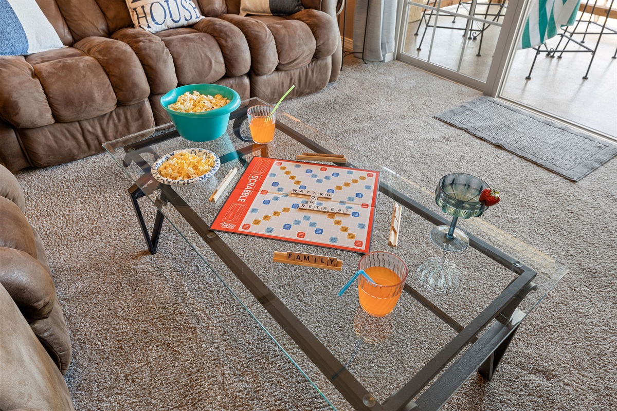 Family game time with the sound of boats going by and waves lapping at the shore