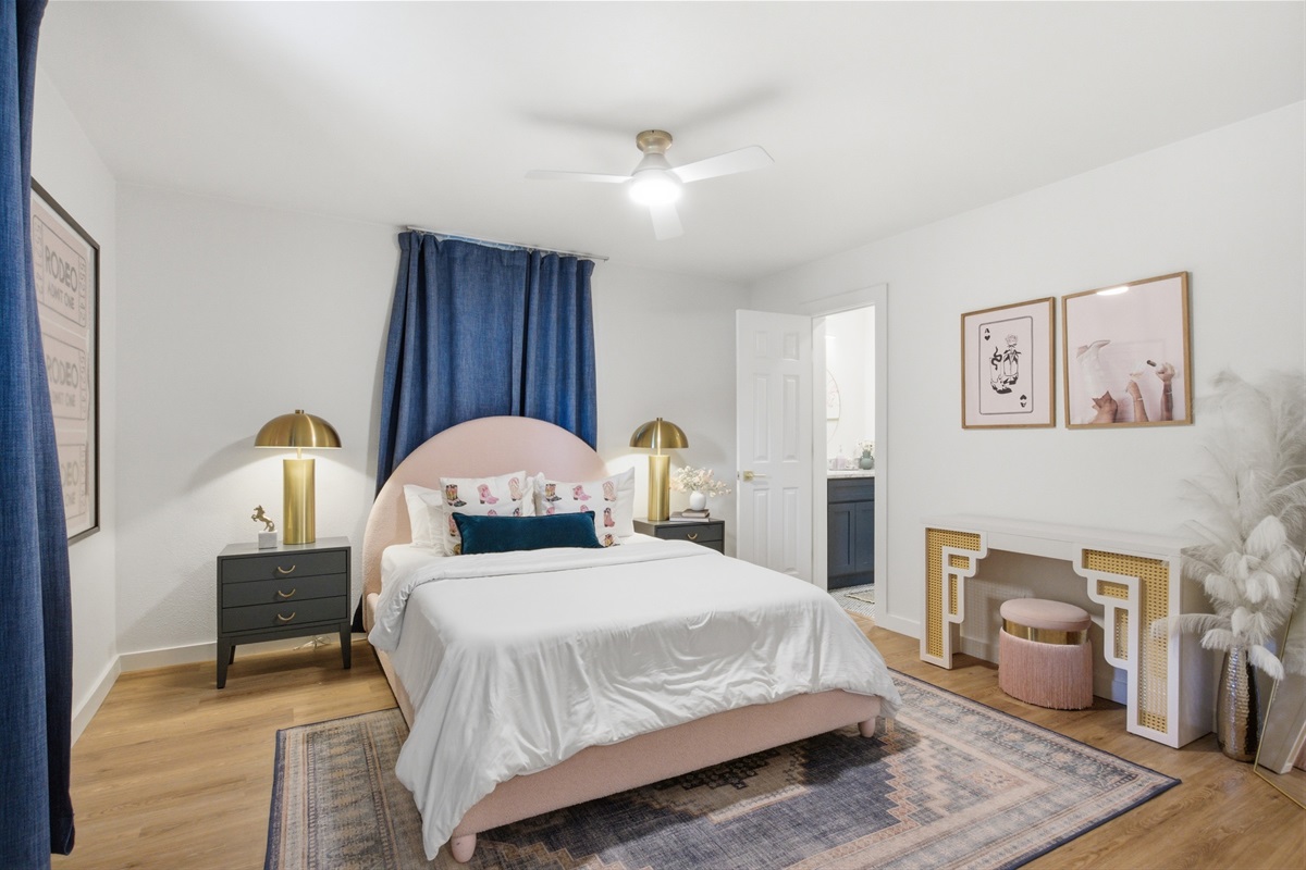 Double bed with gold accent lamp, blue velvet curtains, and room-darkening shades. Lock on bedroom door. 4-bedroom Arlington home sleeps 8 near AT&T Stadium.