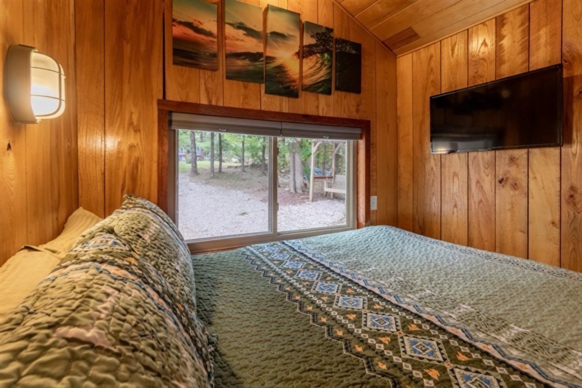 Cozy queen bed with peaceful forest views