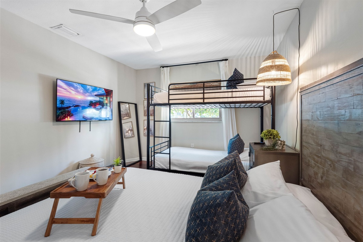 Family-friendly bedroom featuring a full bed and bunk beds, perfect for guests or kids.