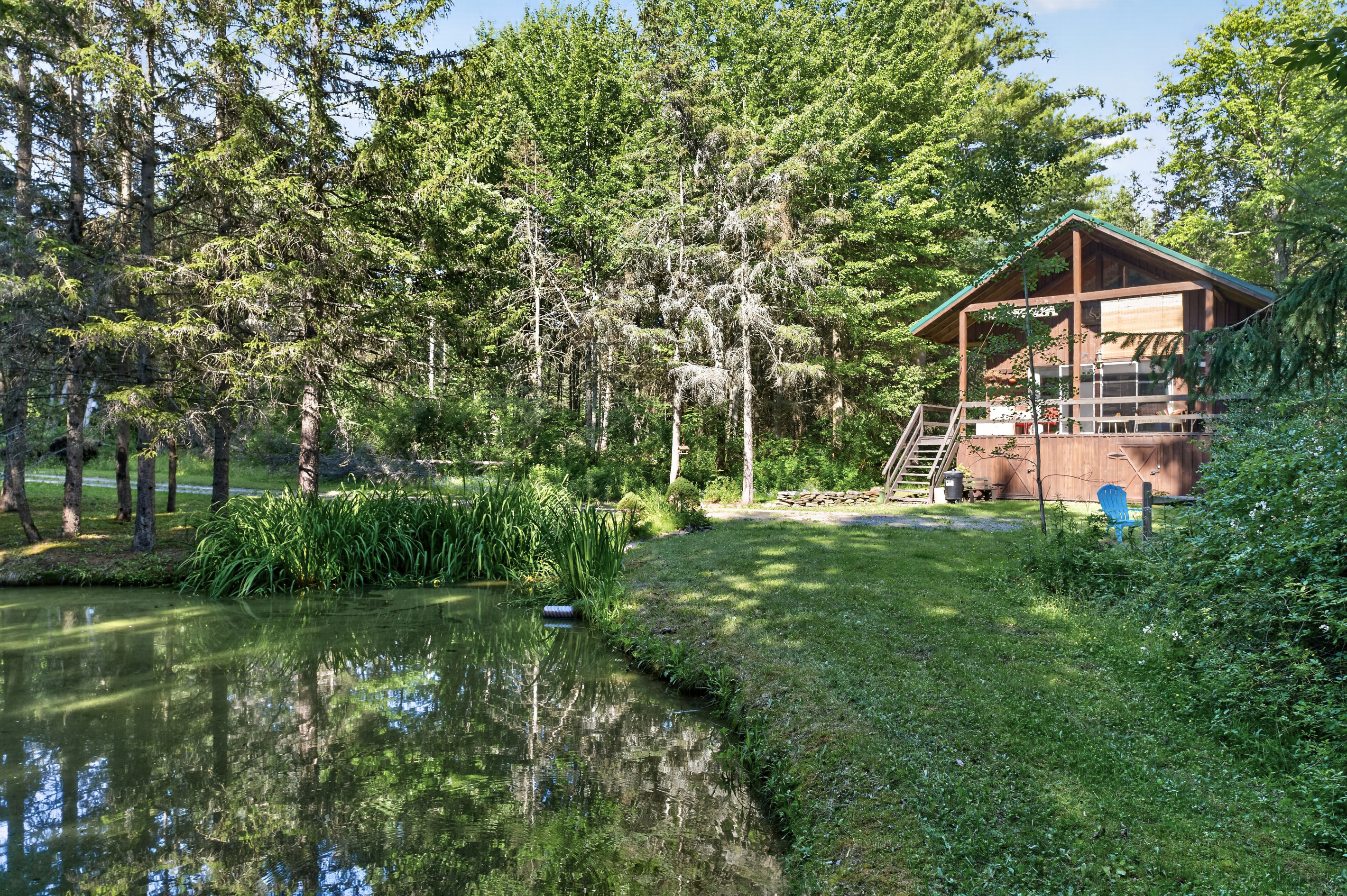 Cabin exterior within the wooded and water view