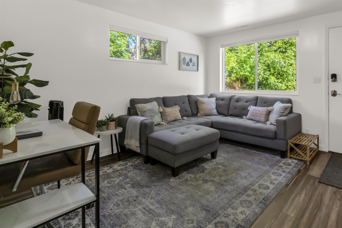 Cozy living room with large windows, very private space.