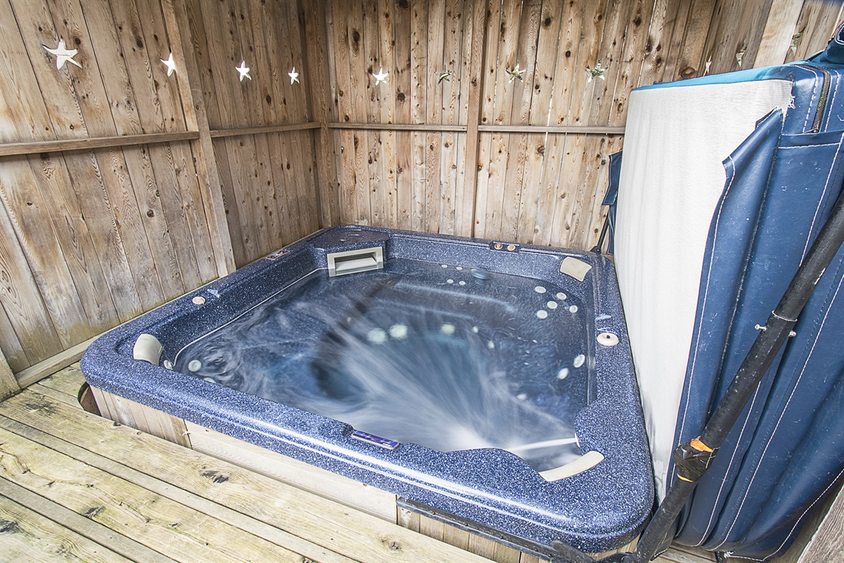 Enjoy a large hot tub that comfortably fits 6–8 guests ~ perfect for relaxing after a day at the beach!