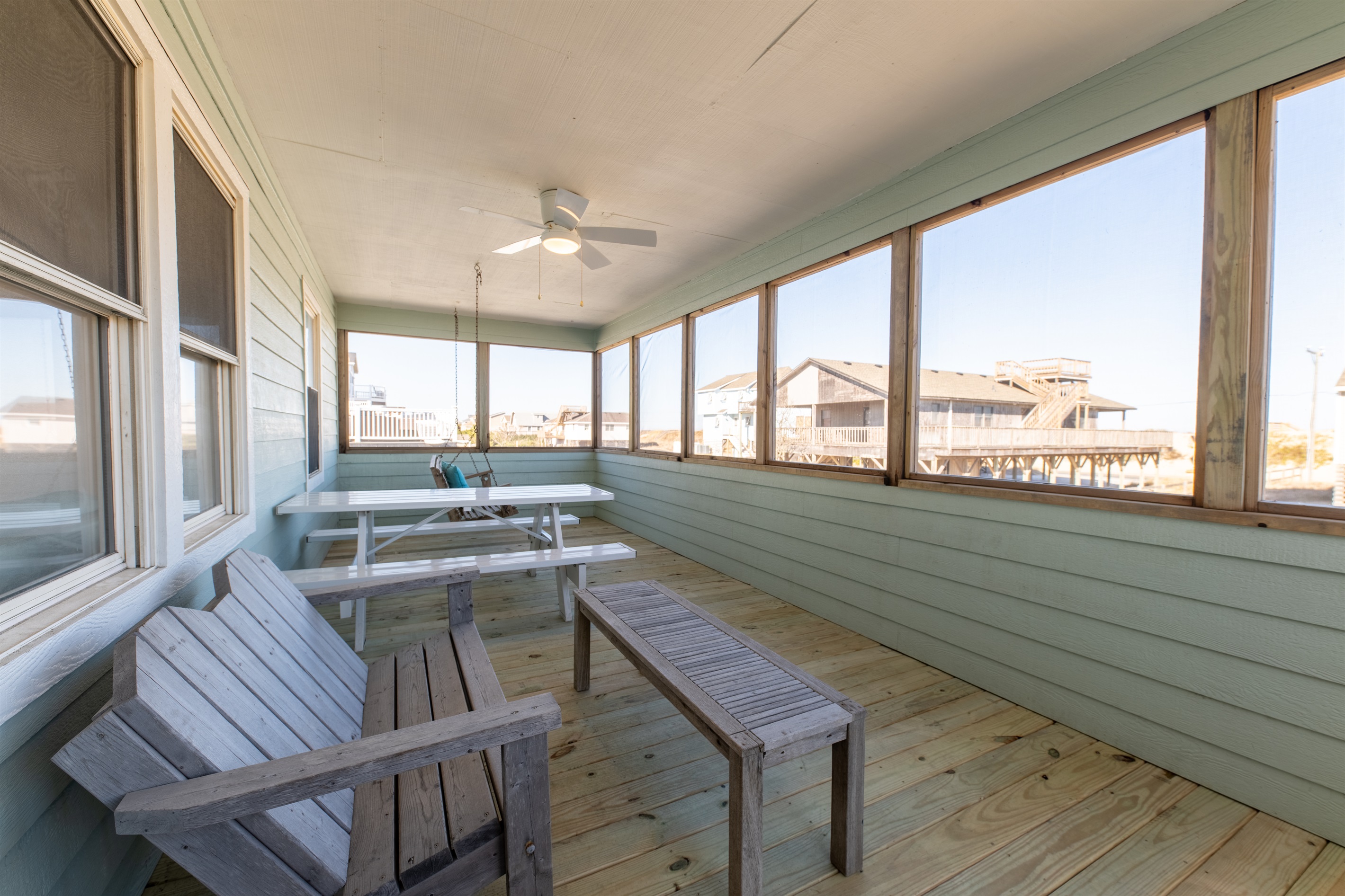Listen to the waves or enjoy the sunrise while spending time outdoors in the large screened in porch