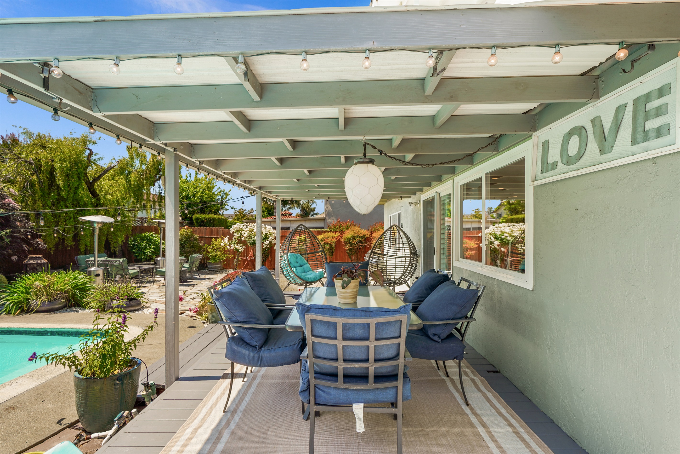 Private backyard retreat with a sparkling pool, outdoor seating, and space to relax and enjoy Napa Valley’s beautiful weather.