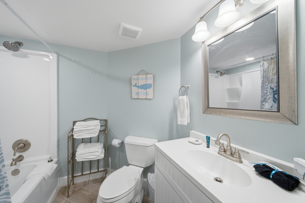 Full bathroom with tub/shower combo and a large vanity mirror