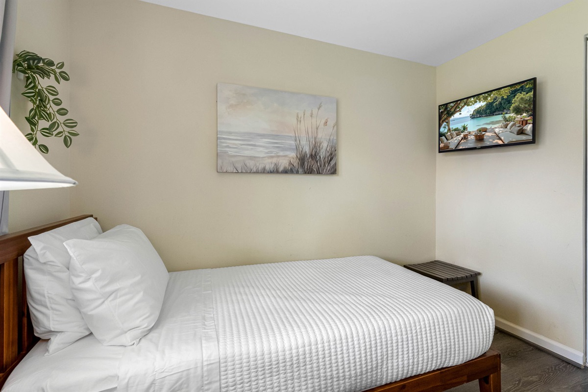 Set against warm, neutral walls and stylish wood-look flooring, the space feels both modern and relaxing.