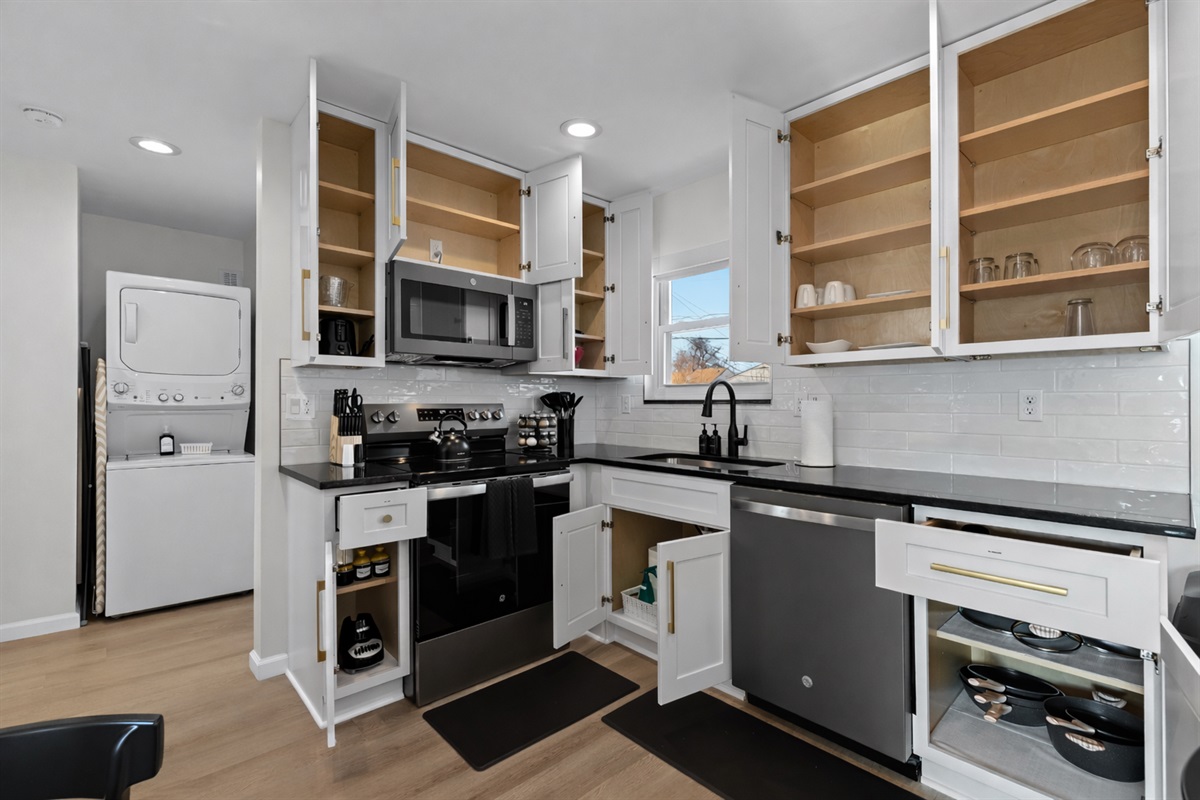 Fully stocked kitchen with ample cabinet storage, modern appliances, and everything you need for easy cooking, dining, and extended stays.