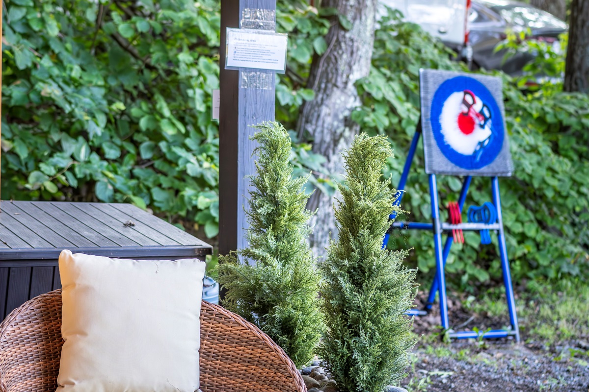 Kick back in the papasan chair or try your hand at our safe, plastic axe throwing set—fun for all ages right outside the sauna, under twinkling lights